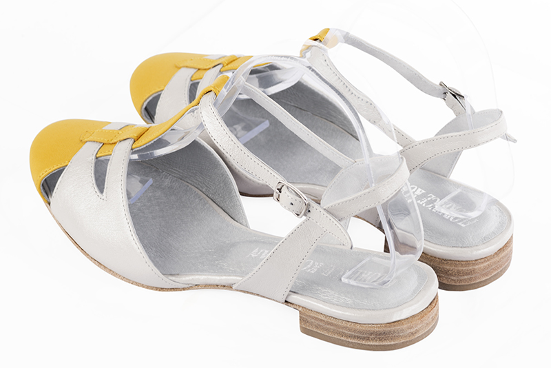 Yellow and pure white women's open back T-strap shoes. Round toe. Flat leather soles. Rear view - Florence KOOIJMAN